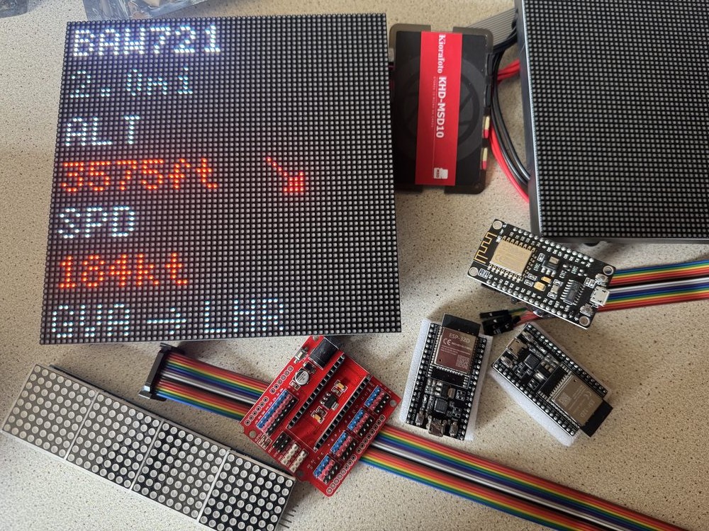ESP32 boards and a smaller secondary LED matrix panel on the bench