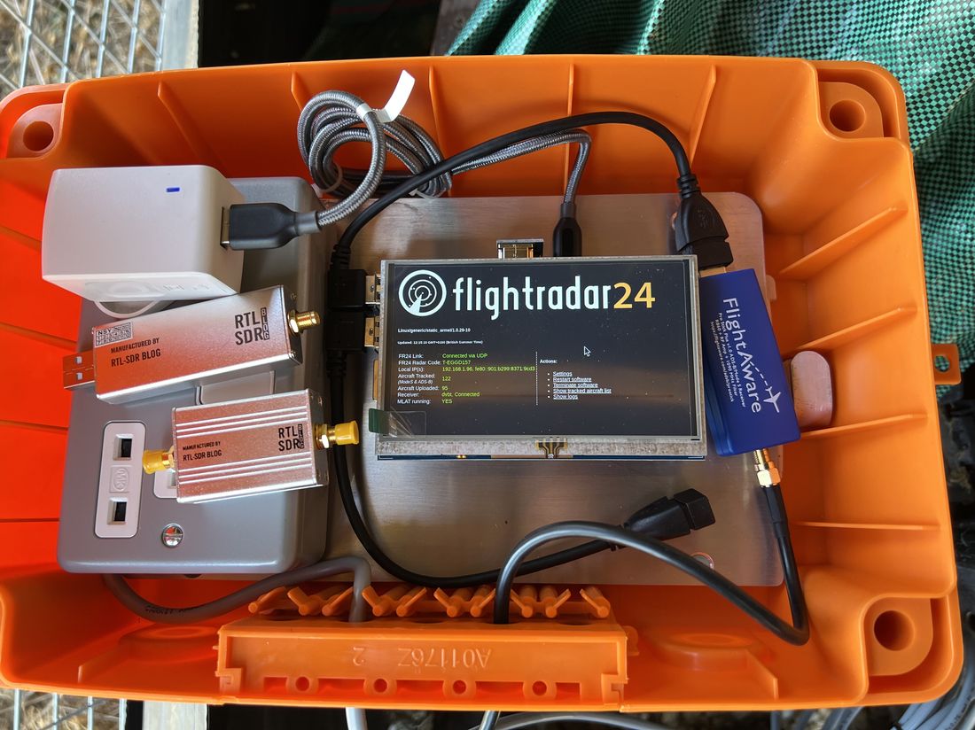 The original 5-inch touchscreen FlightRadar24-style prototype, housed in an orange case with RTL-SDR receivers