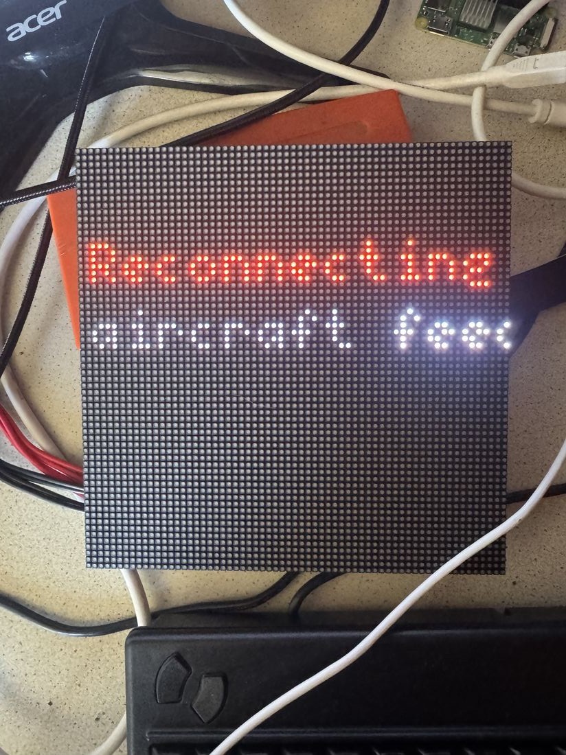 The Raspberry Pi, bonnet, ribbon cable, and LED panel wired together on the bench
